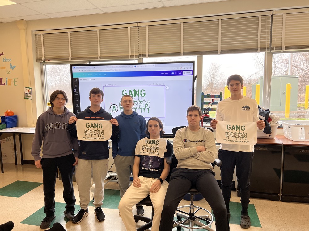 Students in Mr. Jordan Gannett’s intro to business class pose for a photo with the rally towels they designed as part of a class entrepreneurship project. (Photo courtesy of Jordan Gannett) 