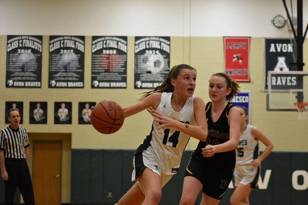 Photo courtesy of High School Yearbook Club:  Freshman guard Maria G. drives to the basket during a home game against Pavilion in December. 
