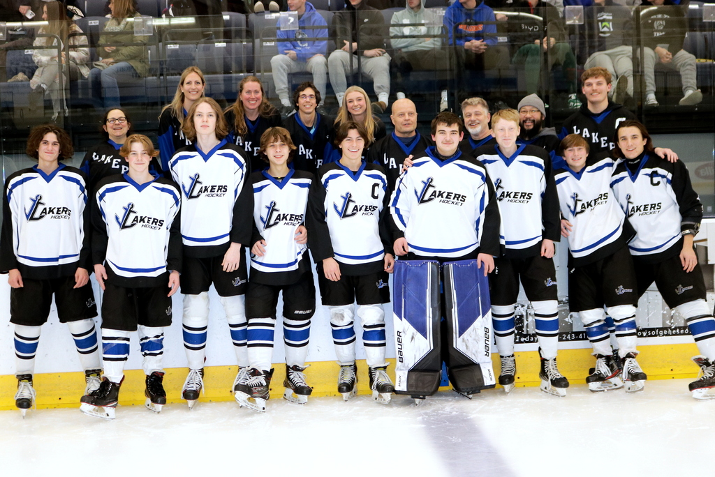 Avon hockey players and their appreciated teacher pose for a photo during the team’s teacher appreciation night game last week. 