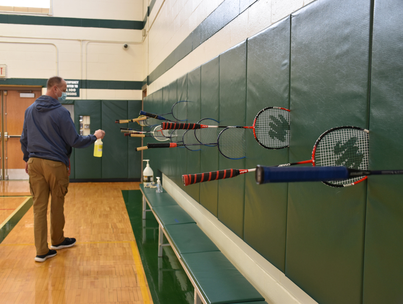 As part of the COVID protocol, Mr. Zarzycki cleans rackets at the end of class.