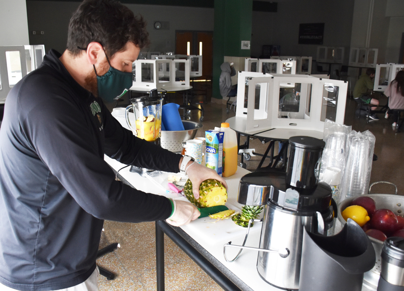Mr. Cole prepares a smoothie for the class.